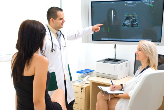 A doctor shows the ultrasound image on the monitor