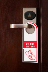 Hotel door handle with "do not disturb" sign
