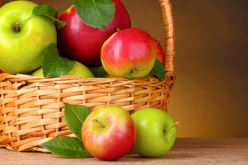 Basket of organic apples on brown background