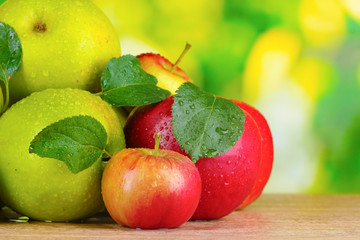Fresh organic apples on wooden table isolated on white