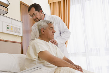 Doctor examining patient in hospital room