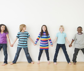 Friends holding hands in a row