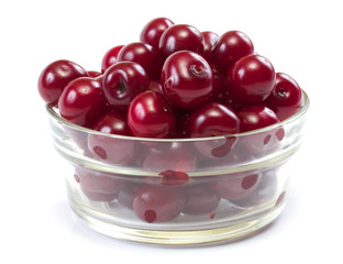 Bowl with ripe cherries. Isolated on a white background.