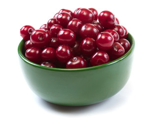 Bowl with ripe cherries. Isolated on a white background.