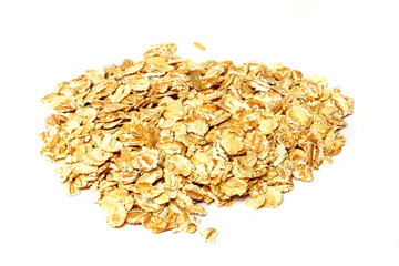 Heap of dry rolled oats isolated on white background