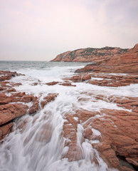 rocky sea coast and blurred water