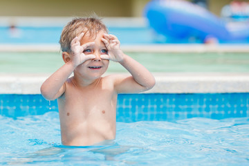 boy playing in a pool of water