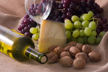studio shot of wine, cheese and nuts