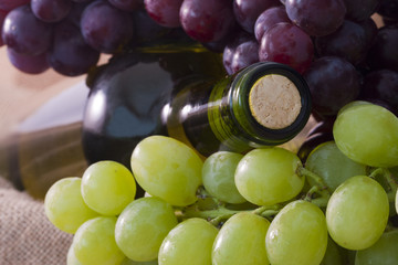bottle of wine with grapes