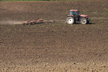 Fototapeta premium Tractor plowing the field