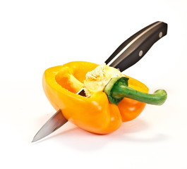 cut yellow paprika with knife  isolated on white background