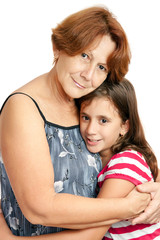 Latin grandmother hugging her granddaughter