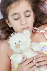 Beautiful latin girl sleeping with her teddy bear