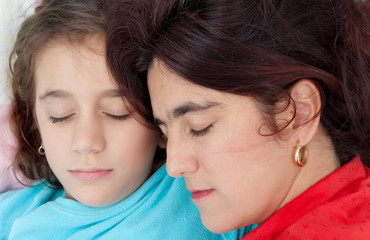 Portrait of an hispanic mother and daughter sleeping