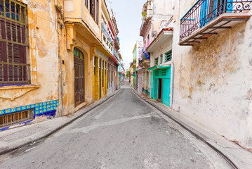 Colorful street in Old Havana sidelined with decaying buildings