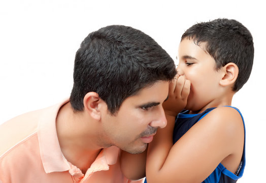 Boy Telling A Secret To His Young Father Isolated On White