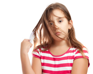 Portrait of a cute latin girl combing her hair