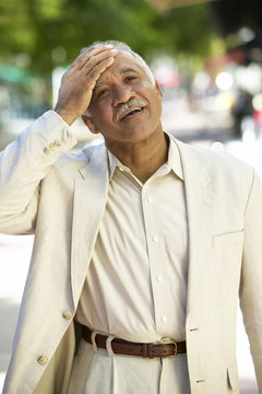Relieved Hispanic man standing outdoors