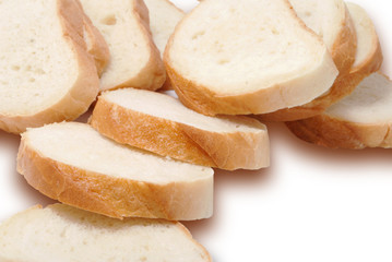 A long loaf of white bread cut into pieces