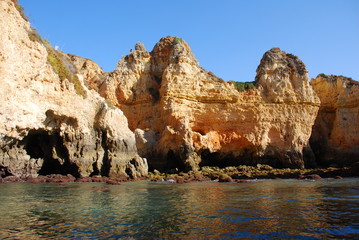 Caves in the cliffs yellow in Lagos in the Algarve Portugal