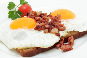 Spiegeleier mit Speckwürfeln auf Graubrot