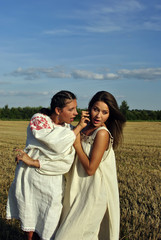 Two girls in a rural clothing talking on the phone