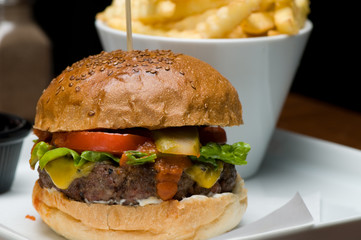 Tasty hamburger with fries.