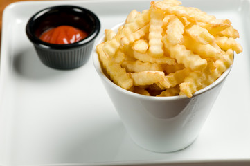 French fries and ketchup on plate.