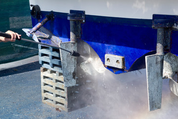 blue boat hull cleaning pressure washer barnacles