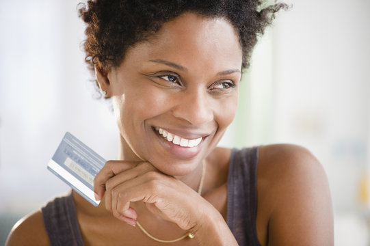 Black woman holding credit card