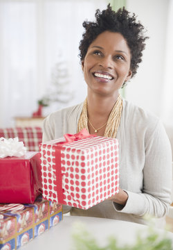 Black woman holding wrapped gift