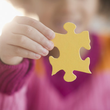 African American girl holding puzzle piece