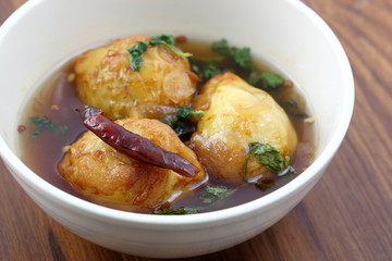 Thai food boiled egg fried with tamarind sauce in wood backgroun