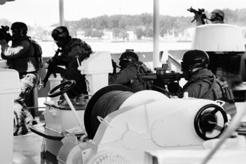 Soldiers marines  boarding a ship in a simulated assault.
