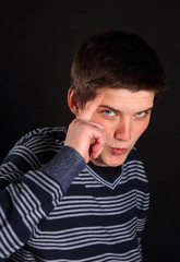 A teenager making a sign