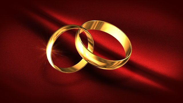 Gold rings against a red fabric