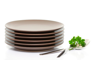 Plates, fork, spoon and parsley