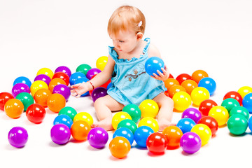 Fototapeta na wymiar baby girl play with balls