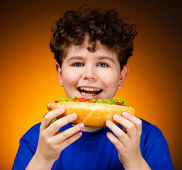 Boy eating big sandwich