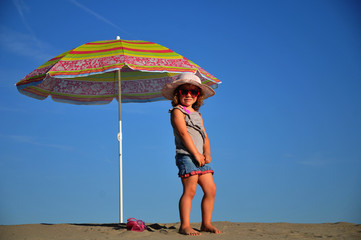 Girls on the beach under a beach umbrella