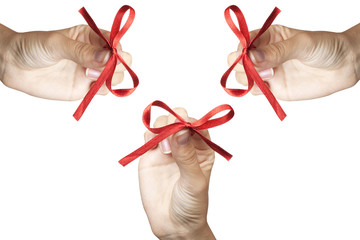 Red bow in hands isolated