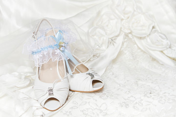 Bride's shoes garter, with blue ribbon, wedding dress. Closeup o