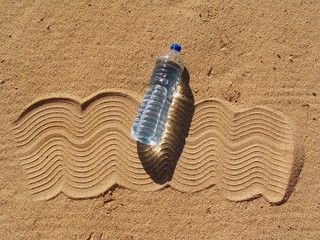 Bottle of water... floating on the beach