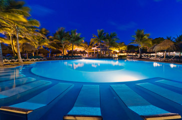 Tropical resort with swimming pool at night
