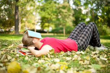 girl relaxing with book on her head