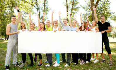 group of people holding big white paper