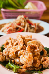 Crispy pork salted rind with thai herbal and papaya salad on the