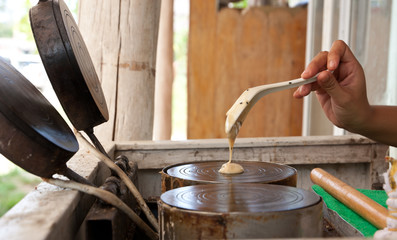 kind of Thai sweetmeat . Coconut milk mix with powder fried dess