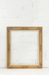 golden frame on white brick wall