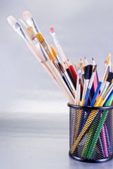 Set of art tools on a chrome background.